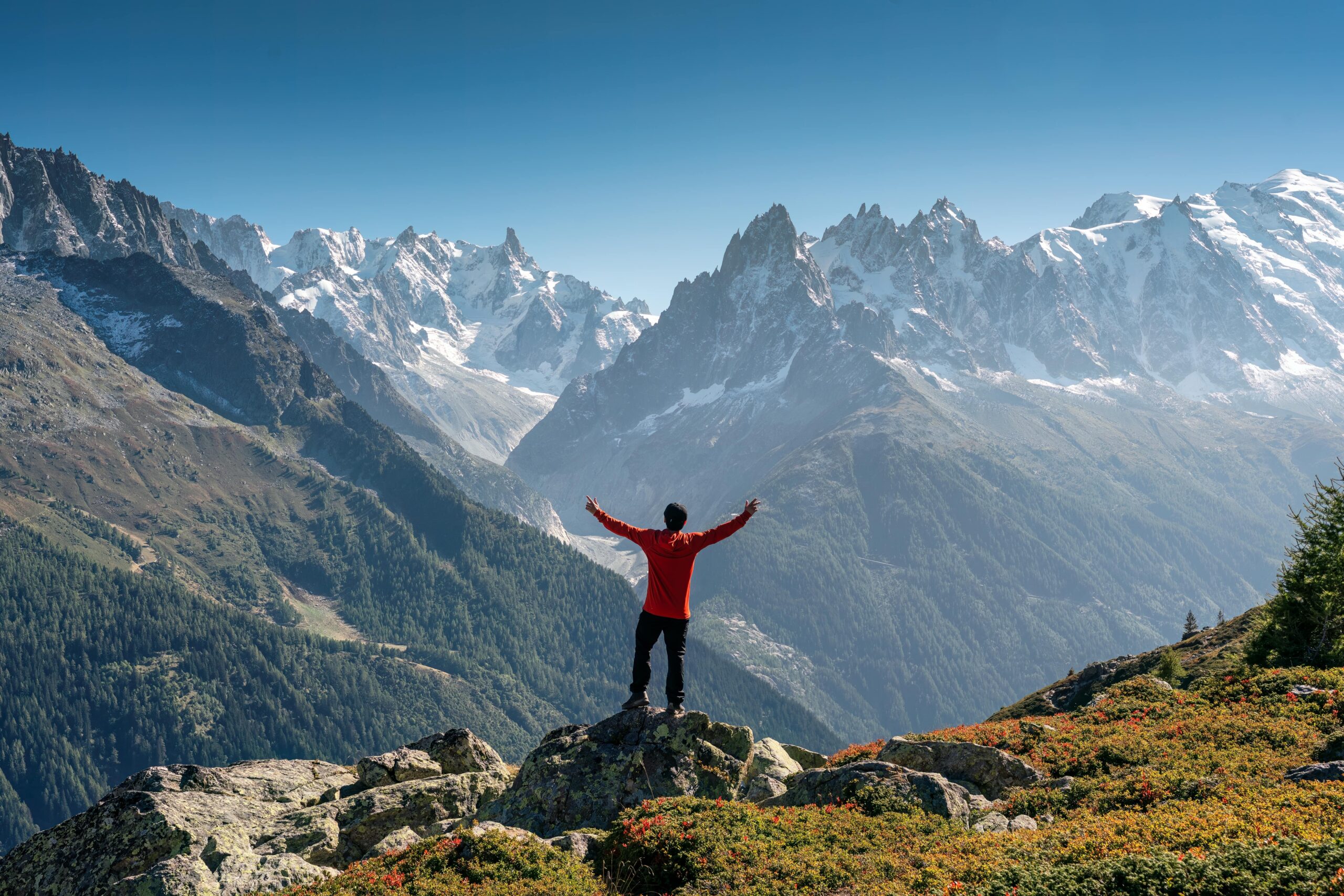 person celebrating sunrise on mountaintop, representing inner strength