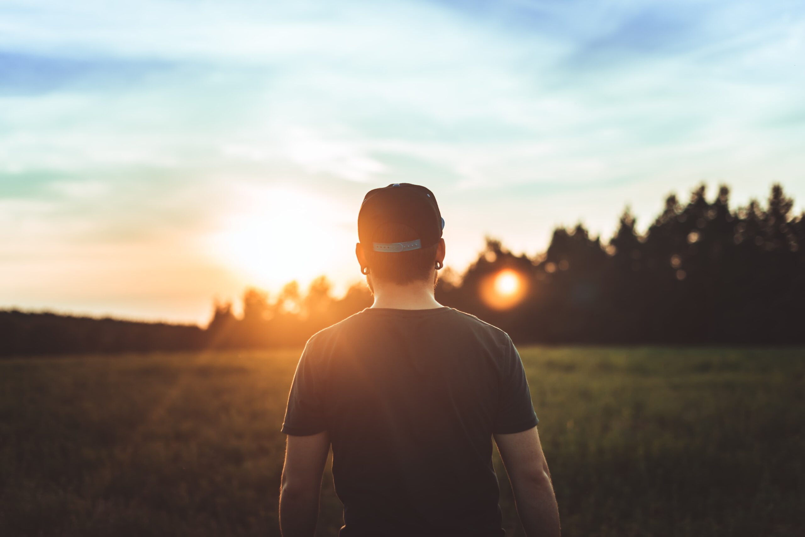 person walking into sunrise symbolizing new beginnings