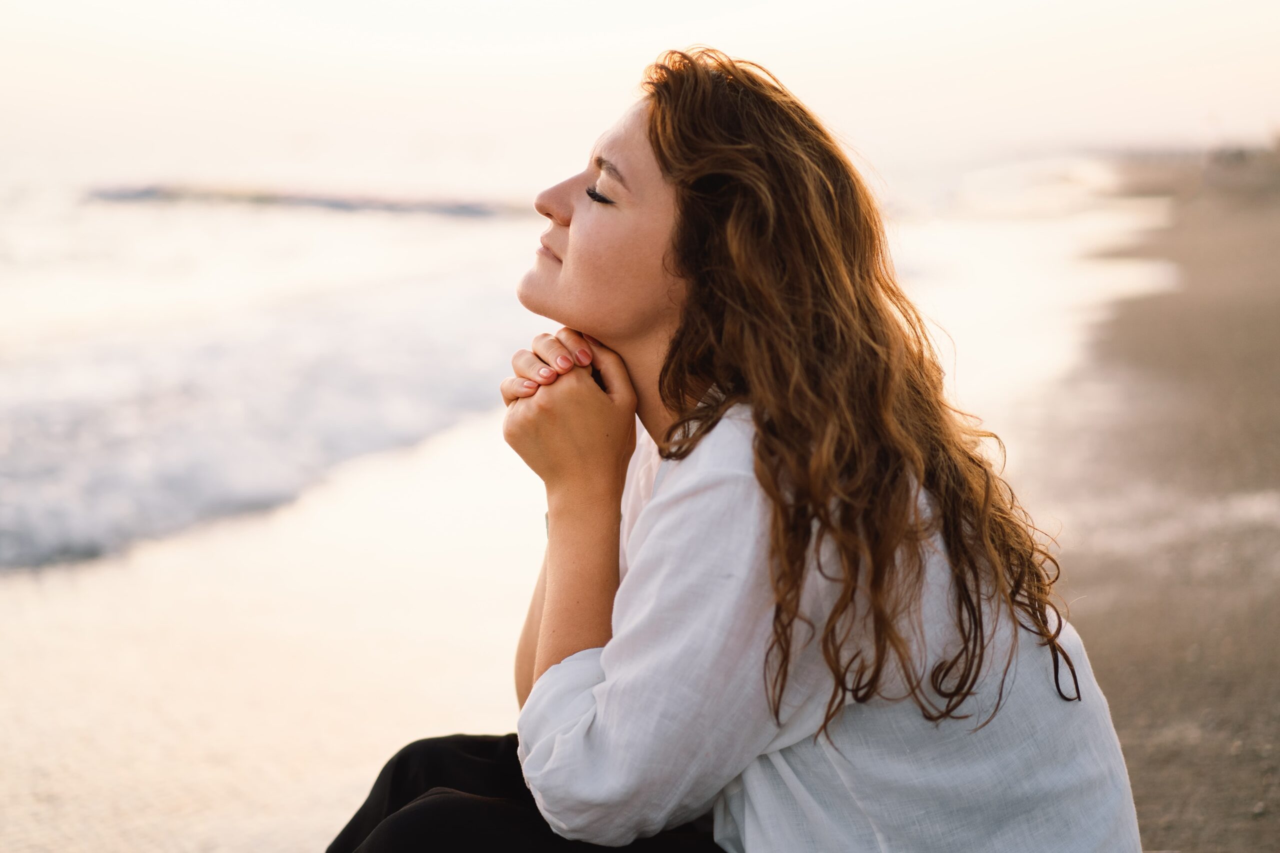 person facing sunrise symbolizing hope and new beginnings in recovery