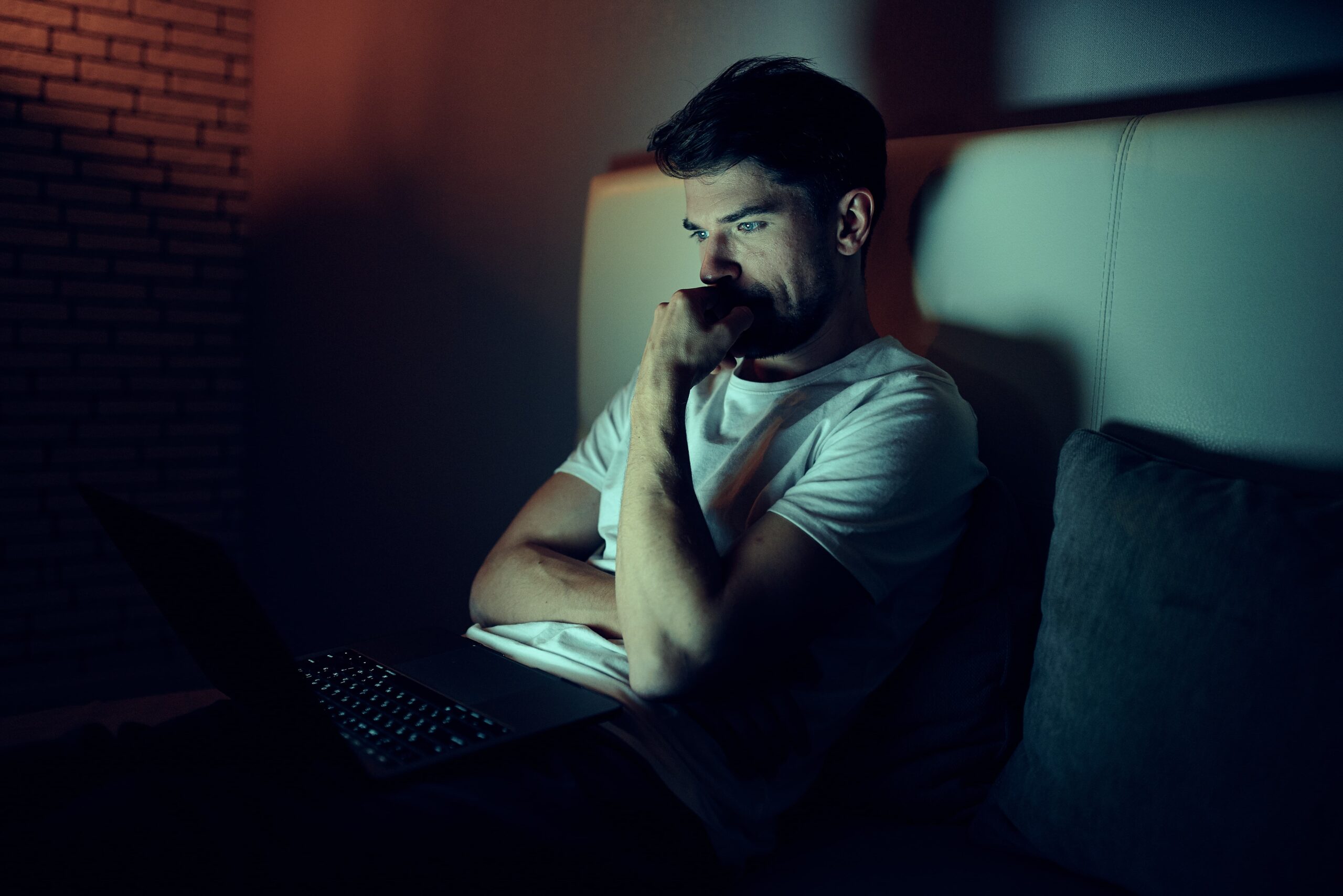 Person struggling with internet use and addiction late at night