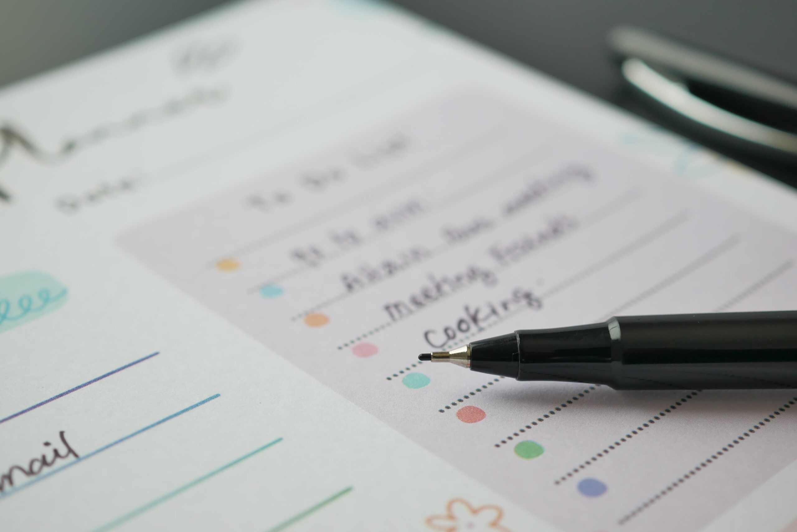 Weekly planner open with color coded time blocks and a subtle phone reminder beside it ADHD and substance use structured routine planning