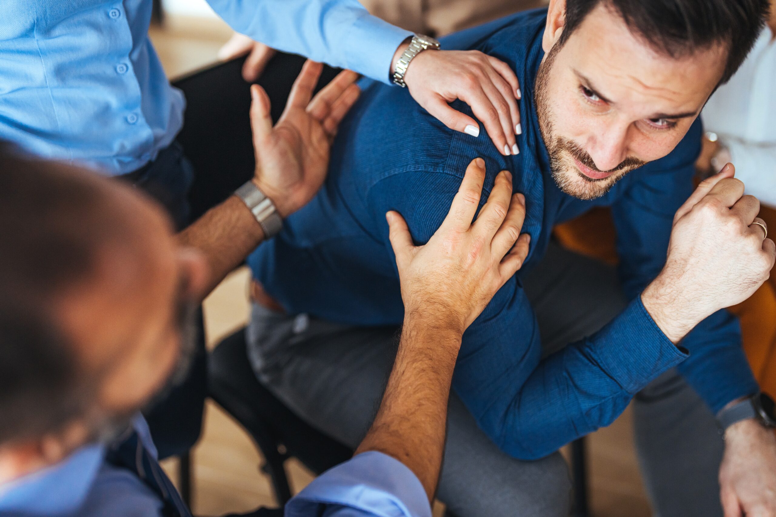 Support group discussing addiction in a calm community setting